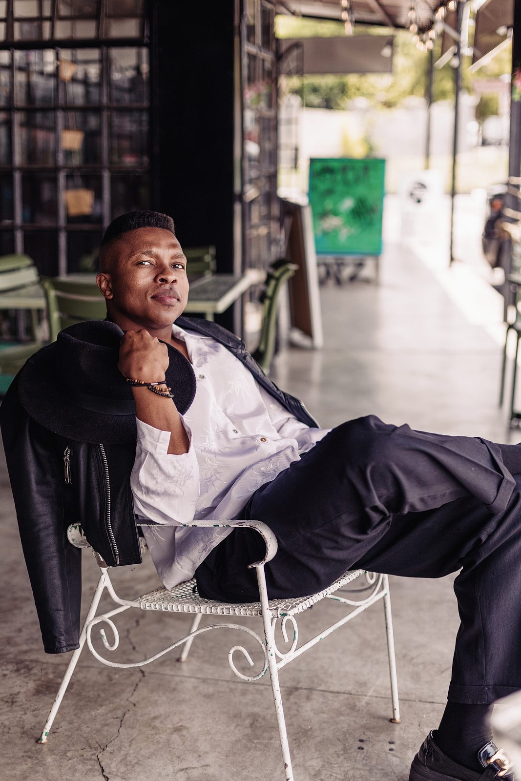 Thuba Myeki relaxing at a cafe table